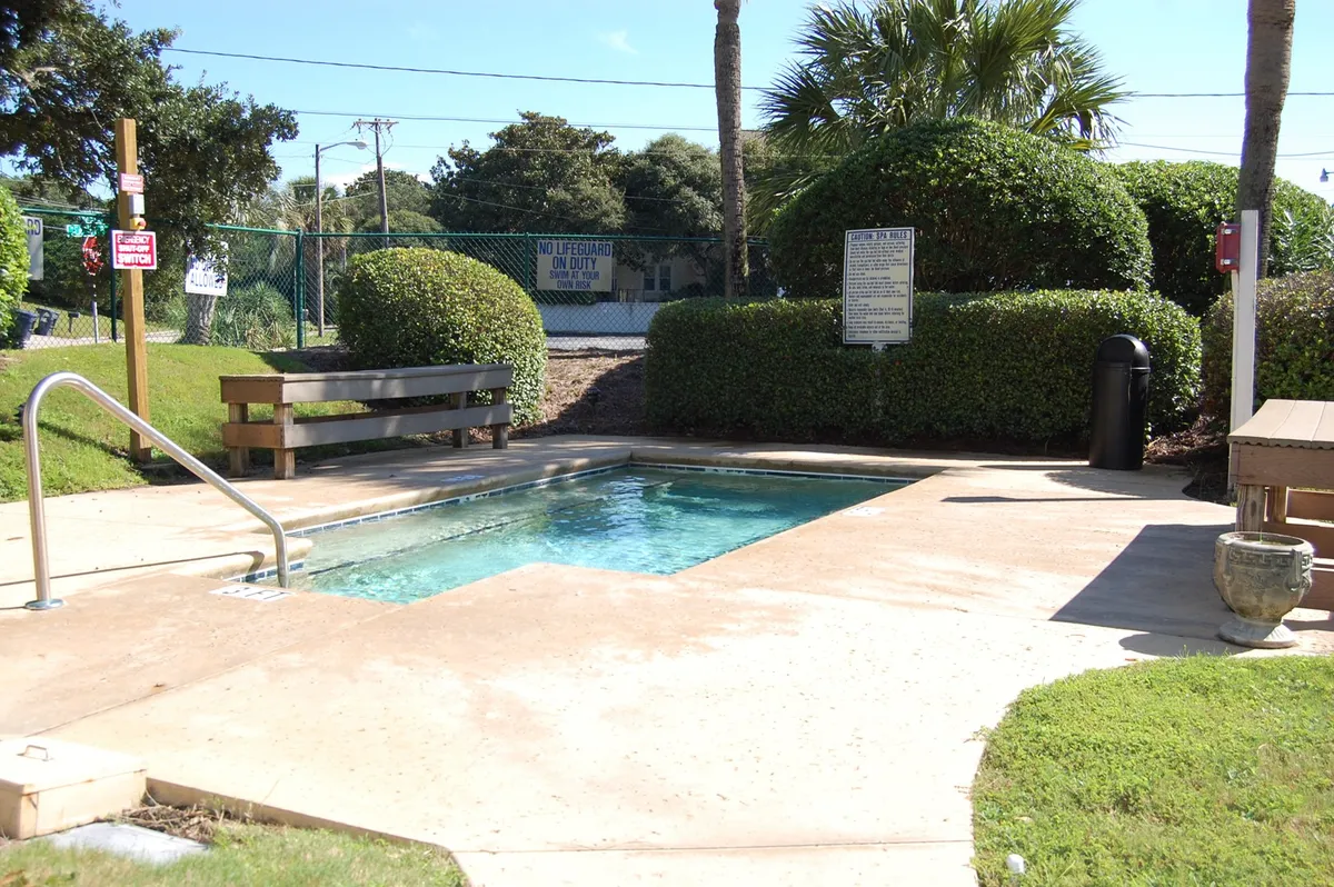 A pool with adjacent benches and landscaping provides a more intimate, inviting setting, ideal for a quiet swim, sun-soaked reading, or small group gatherings. The landscaping adds to the tranquil ambiance.